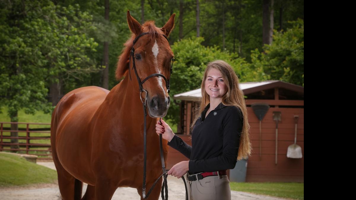 
Adele Norton, a member of the USC equestrian team, is USC’s Scholar-Athlete of the Year. Here, she poses with one of her favorite horses, Cecil. 
