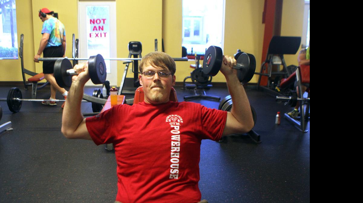 
Jared Rigdon lifts weights at Powerhouse Gym on Thursday afternoon in Bluffton. Rigdon recently lost 100 lbs. and won $1,000 for being the biggest loser in a competition held by the Bluffton gym.
