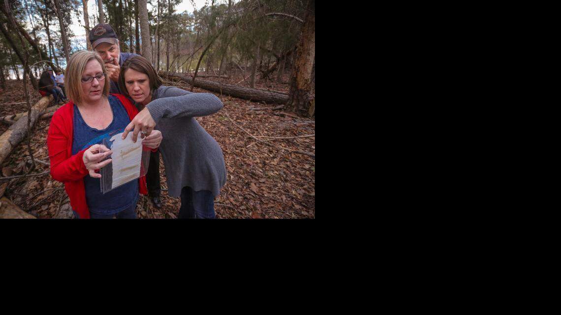
Diane Bryant, left, reads a note she put in a bottle 45 years ago to her then boyfriend, Mike Rogers, center, as Viki Garrick watches. Garrick’s son, Nolan, Rogers’ grandson, found it.



