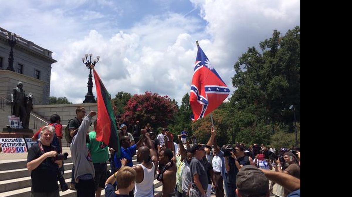 
Klansmen wave the Confederate battle flag Saturday at the S.C. State House.

