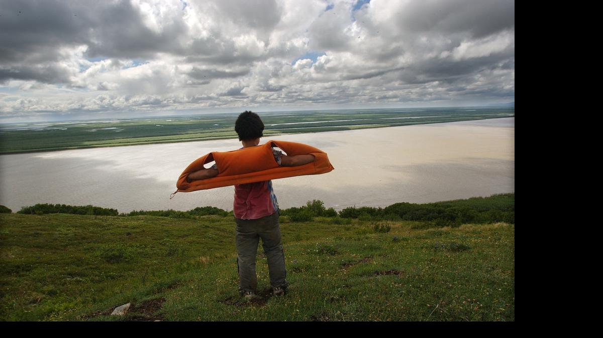 
Edward Prunes, 11, catches the wind while taking in a view of the Yukon Delta atop Azachorok Mountain following a short hike from his home in Mountain Village. 
