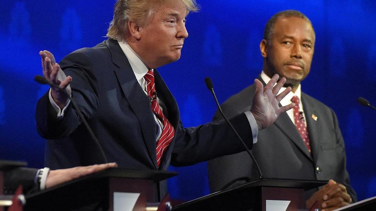Ben Carson, right, watches as Donald Trump speaks during the CNBC Republican presidential debate at the University of Colorado Oct. 28 in Boulder, Colo.