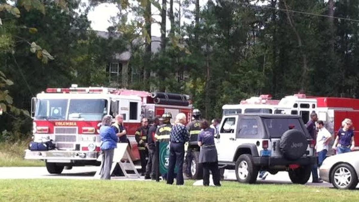 
Emergency responders tend to a State Guardsman injured in a hit-and-run while directing traffic outside of Harvest Hope Food Bank on Shop Road Friday. 
