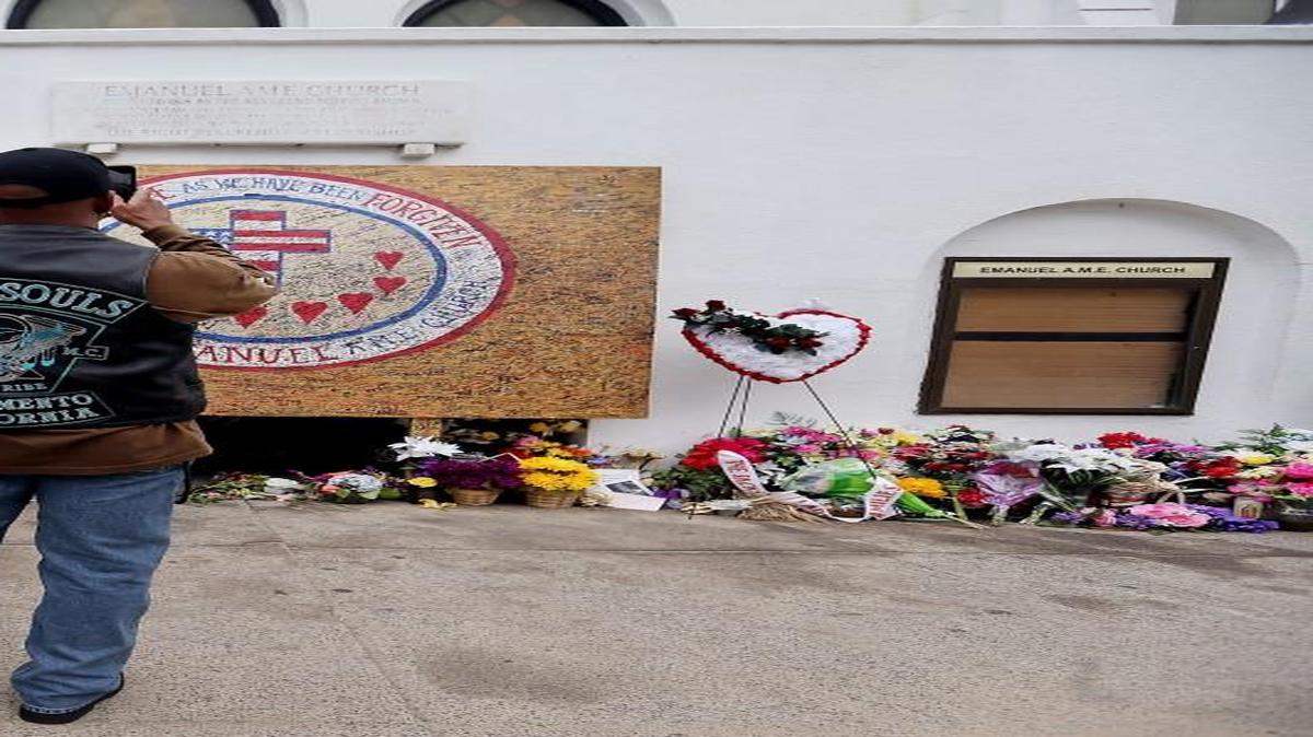 
Raphael Frazier, who traveled with his motorcycle club Iron Souls, from Sacramento, Calif., takes photos outside Emanuel AME Church on in Charleston on Aug. 4. 
