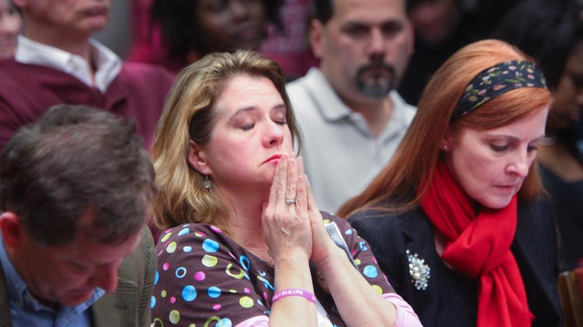 Karen Longstreet, center, David Longstreet, left, and Katie Parham take a moment as the House Judiciary committee votes on Emma’s Law. The proposed legislation was carefully watched and passed both the House and the Senate in 2014.