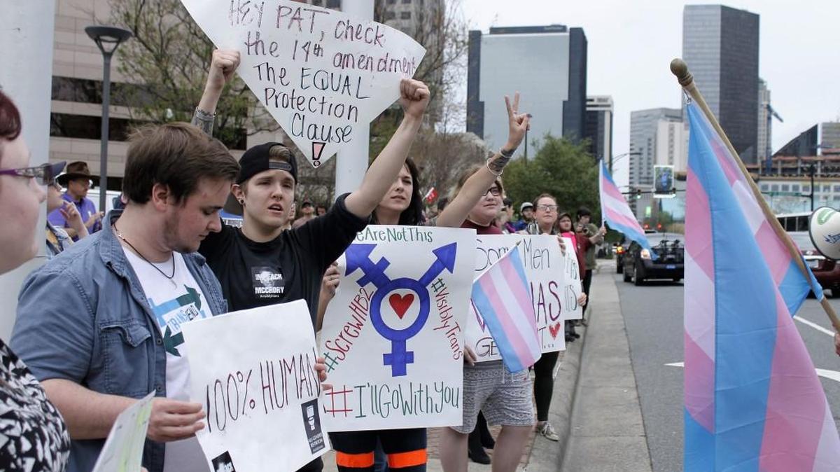 Demonstrators protesting passage of legislation limiting bathroom access for transgender people stand in front of the Charlotte-Mecklenburg Government Center in Charlotte/