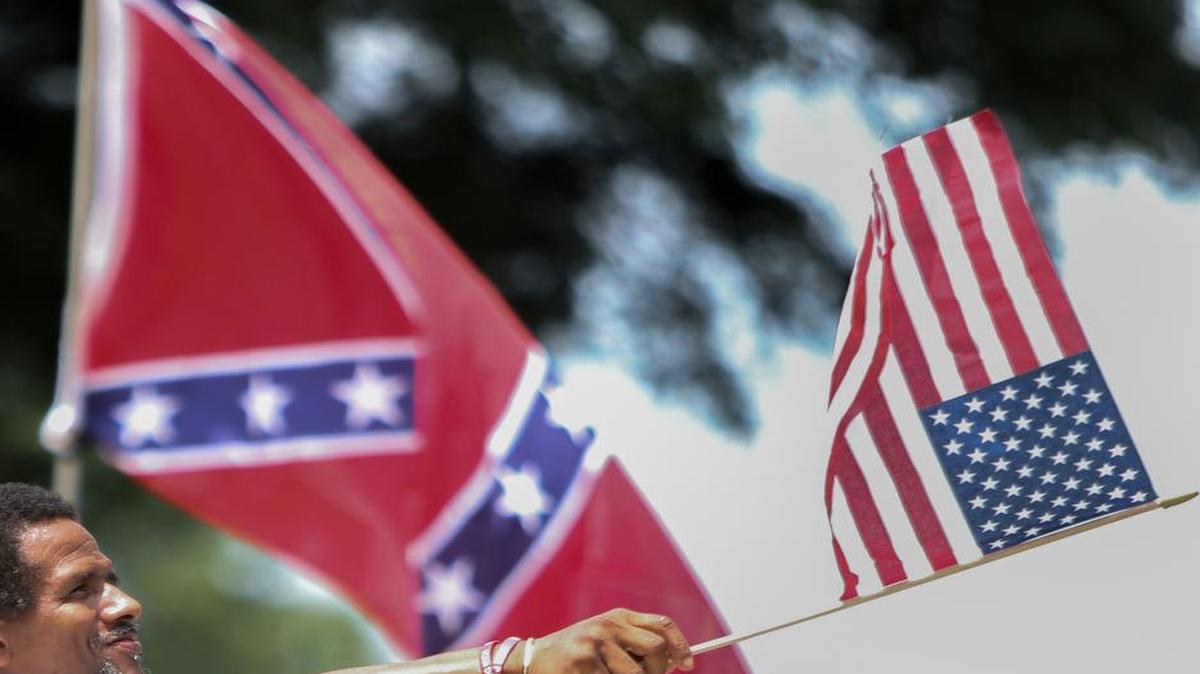 Thomas Wiggins, of  Columbia, waves an American Flag while showing support to take the Confederate flag off the South Carolina Statehouse grounds.  7/7/15