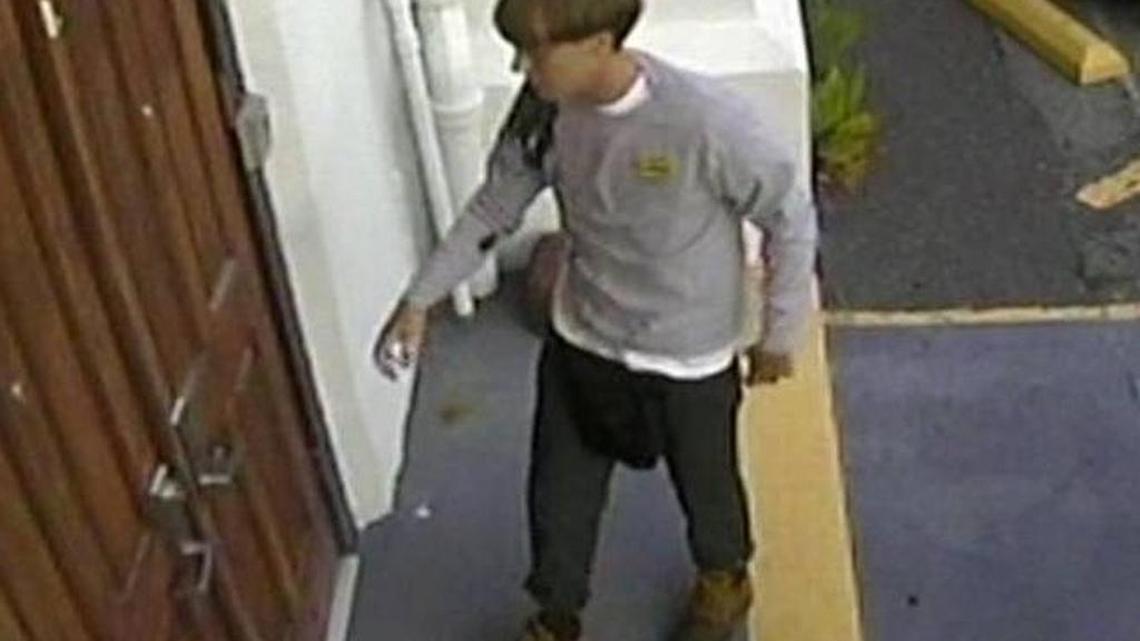 
Surveillance video screenshot: Dylann Roof, wearing what his friends said was his favorite shirt, reaches for door knob to enter Charleston's Emanuel AME church June 17, 2015.
