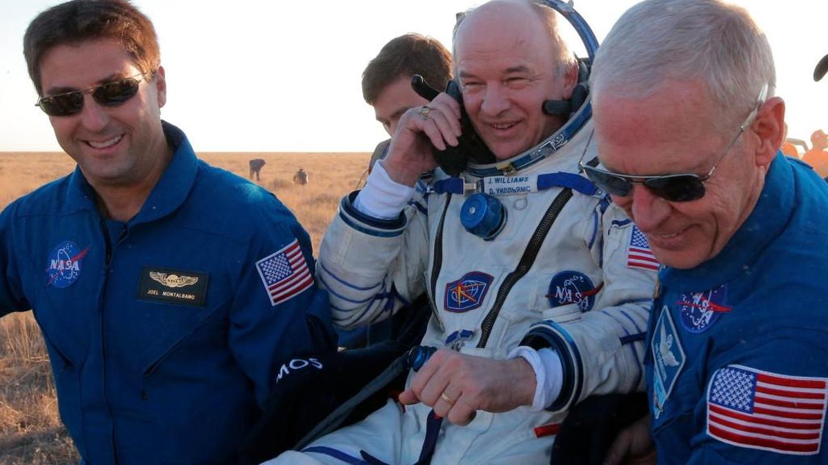U.S. ground personnel carry U.S. NASA astronaut Jeff Williams after landing in a remote area near the town of Zhezkazgan, Kazakhstan, Wednesday.