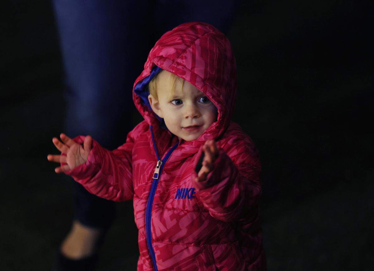 One-year-old Alaina Chasse claps during the opening ceremony of ChristmasVille in downtown Rock Hill on Thursday.