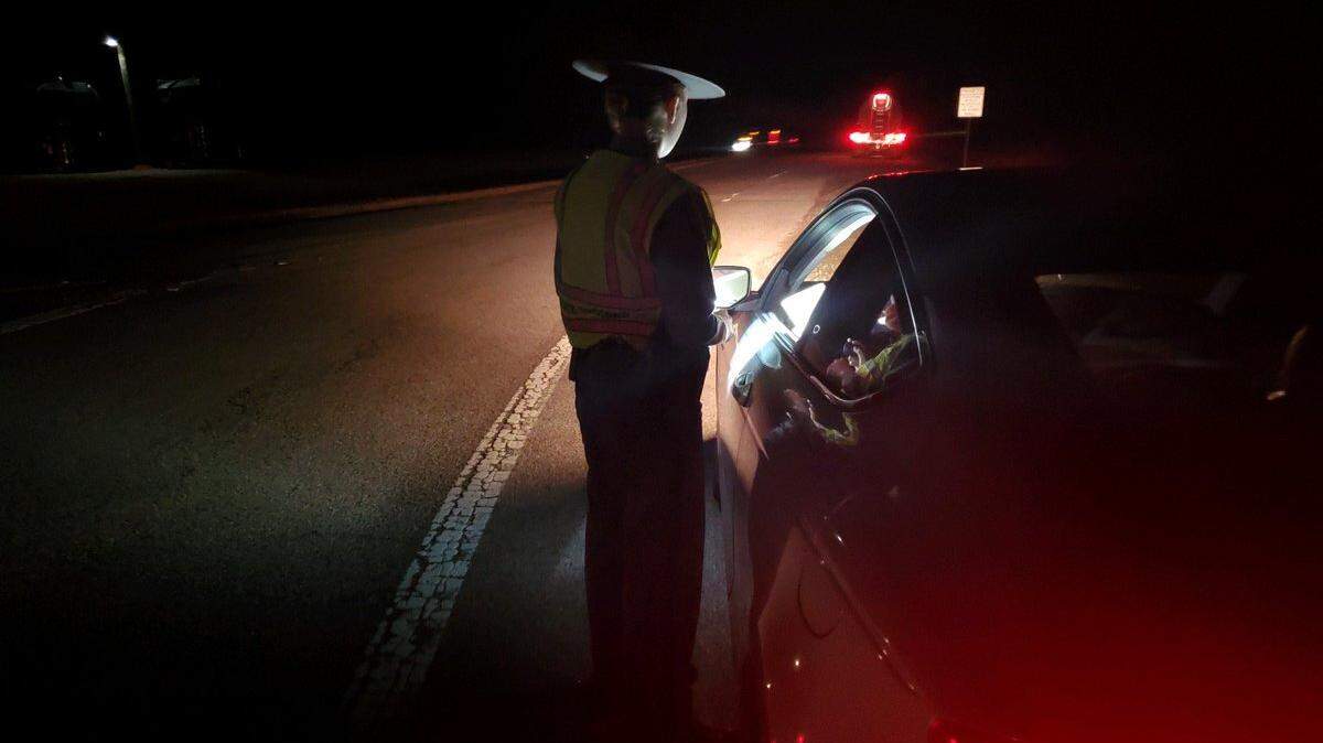 a S.C. Highway Patrol trooper checking a vehicle during a traffic safety checkpoint Monday, Dec. 30. 2019, in Chester County, South Carolina.
