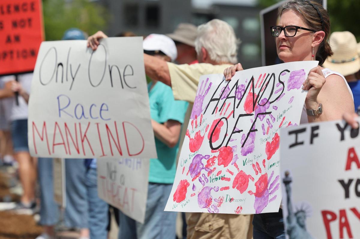 Demonstrators with York County Rising protest President Trump and his policies Sautrday in downtown Rock Hill.