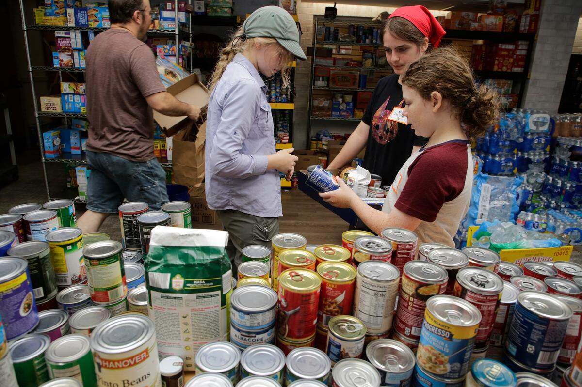 Volunteers at Black Mountain Presbyterian Church sort through groceries on Friday, Oct. 4, 2024