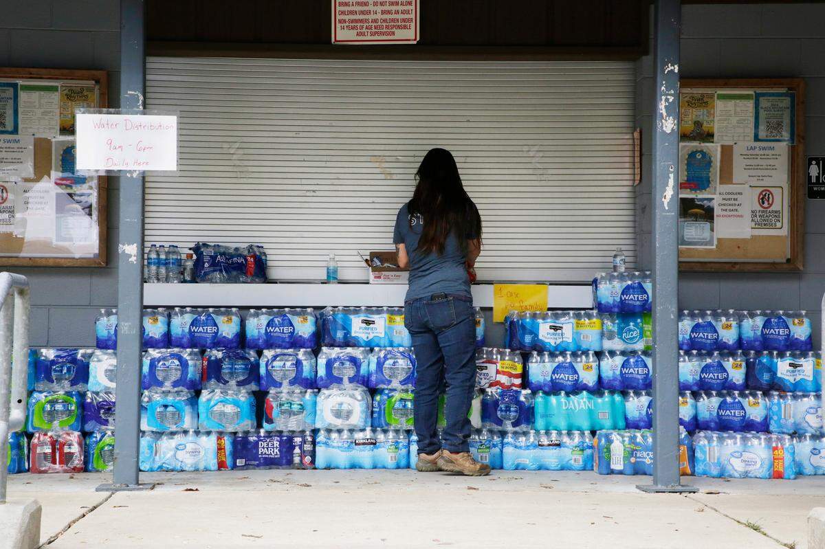 Emily Sampson organizers water bottles at the Black Mountain Parks and Recreation pool Friday, Oct. 4, 2024
