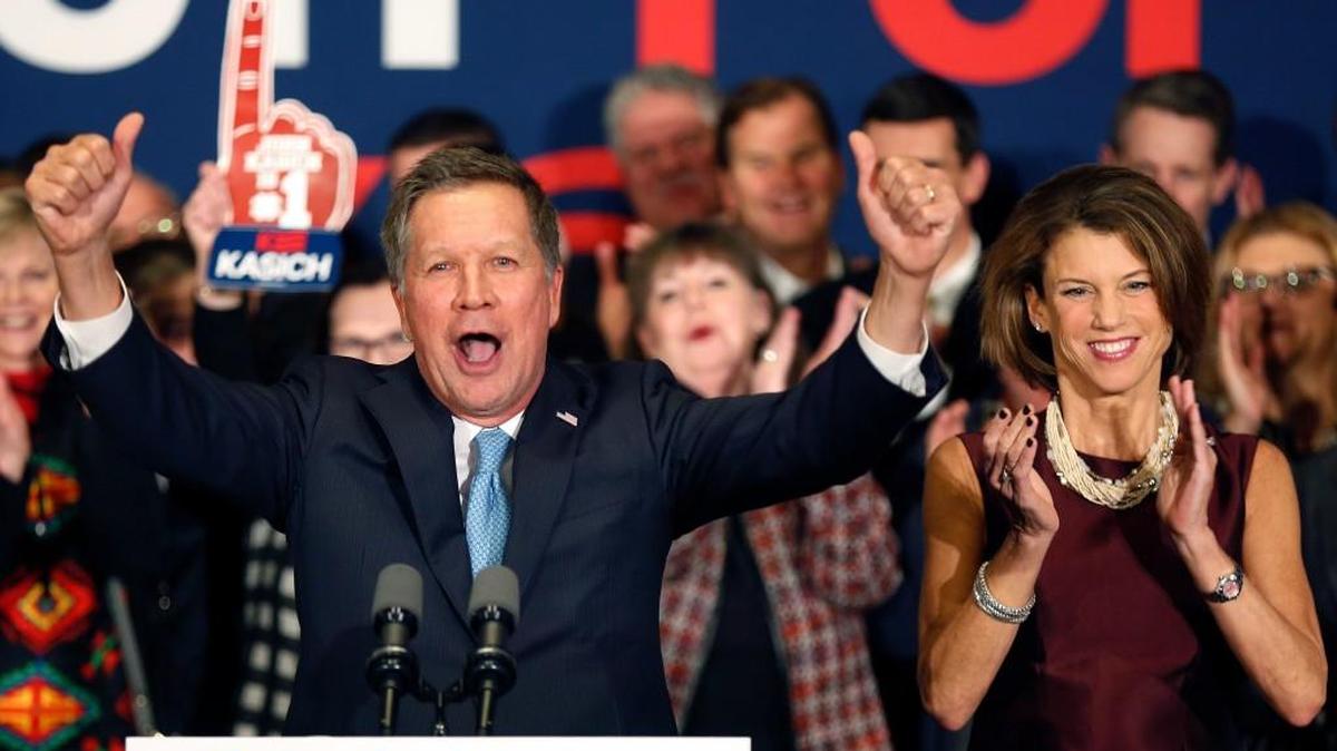 With his wife Karen at his side, Republican presidential candidate Ohio Gov. John Kasich cheers with supporters Tuesday in Concord, N.H., at his primary night rally.