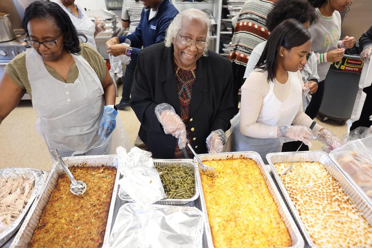 87-year-old Bobbie Brown, middle, participates in her pre-Thanksgiving meal Tuesday at Cedar Grove Baptist Church in Chester.