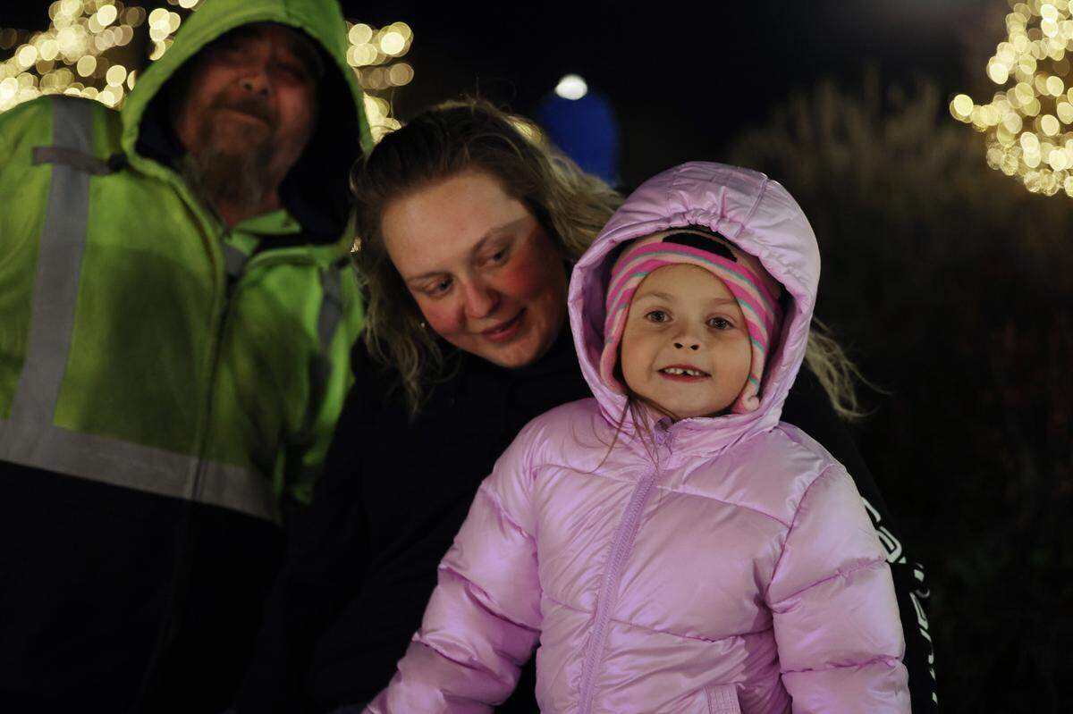 Bobbi-Lynne Barrett, 5, Samantha Barrett, middle, and Donnie Collins watch Santa Thursday at the opening ceremony of ChristmasVille in downtown Rock Hill.