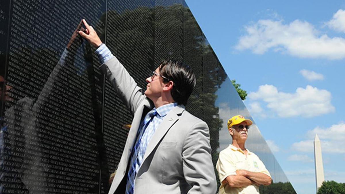 Andrew Brennan, a former Army captain who served as a pilot in Afghanistan, was struck with the idea for a post-9/11 war memorial on the Mall when he witnessed the annual Rolling Thunder visit to the Vietnam Veterans Memorial in 2014. Here he points to the name of a cousin on the wall.