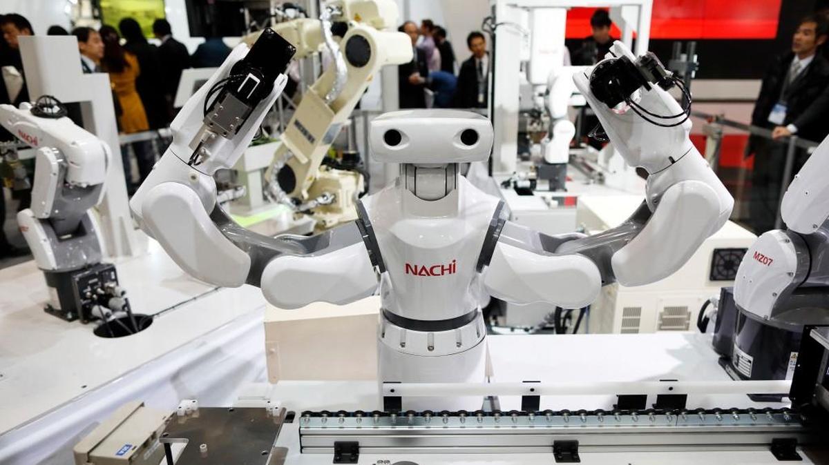 A Nachi-Fujikoshi Corp. industrial robot operates during a demonstration at the International Robot Exhibition 2015 in Tokyo. The creators of artificially intelligent machines are pondering big questions: good versus evil and the impact the coming wave of robots and machine brains will have on human workers.