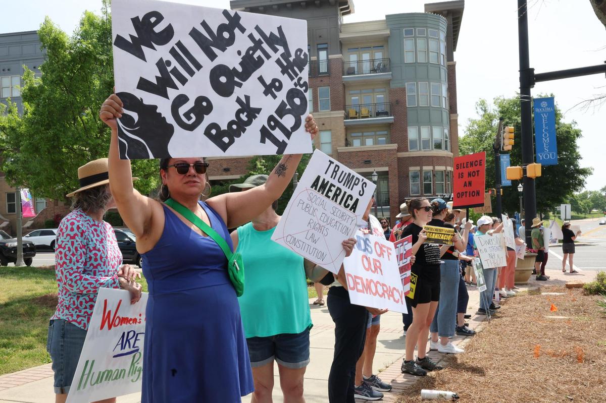 Demonstrators with York County Rising protest President Trump and his policies Sautrday in downtown Rock Hill.