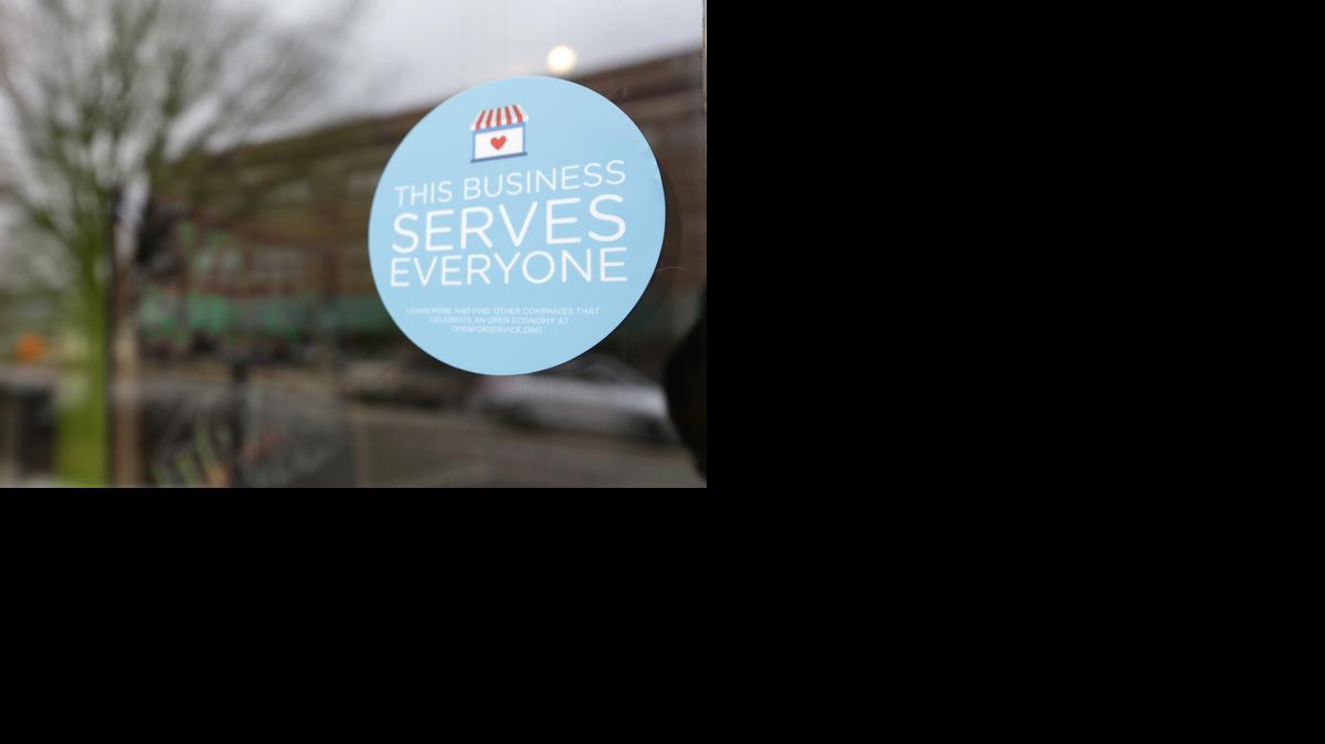 
In this March 25, 2015 file photo, a window sticker promising service to all is displayed in opposition to the state new religious objections law in downtown Indianapolis. Tourism agencies in Indianapolis and Fort Wayne are rolling out campaigns to tout the fact that “All Are Welcome” in Indiana, but it might not be enough to completely heal the black eye the state received over its nationally-criticized religious objections law.
