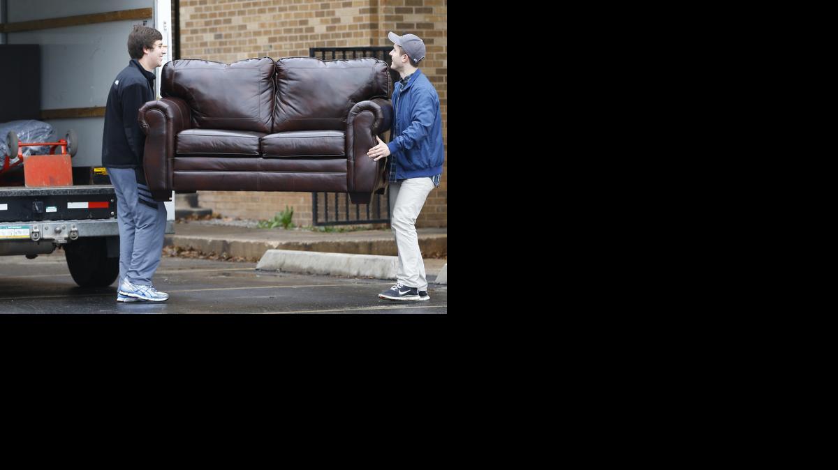 
Two men load a couch from the now closed University of Oklahoma's Sigma Alpha Epsilon fraternity house into a moving truck, in Norman, Okla., Tuesday, March 10, 2015. University President David Boren expelled two students Tuesday after he said they were identified as leaders of a racist chant captured on video during a fraternity event.
