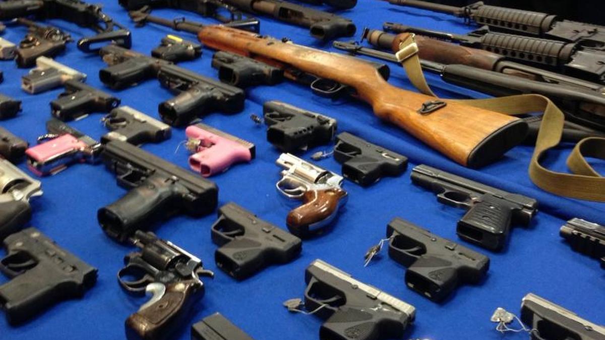Weapons rest on a table during a news conference at the Brooklyn District Attorney’s office, in New York.