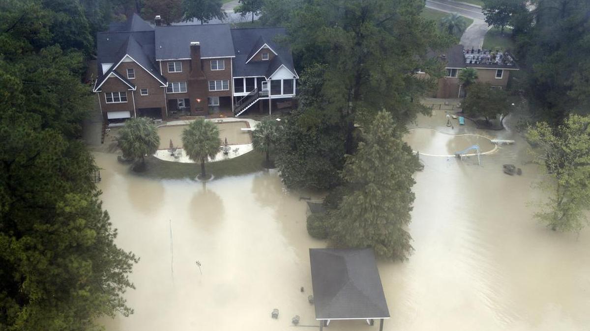 
Floodwaters encroach on lakefront homes in Columbia a day after the rains.

