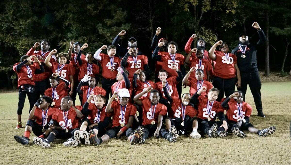 The Pee Wee Falcons pose for a picture after winning a state championship on Tuesday night in Rock Hill.