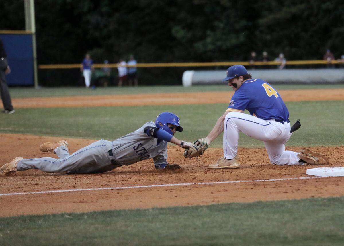 Fort Mill’s Eli Craddock tries to tag Berkley’s Jack Hedges at third base.