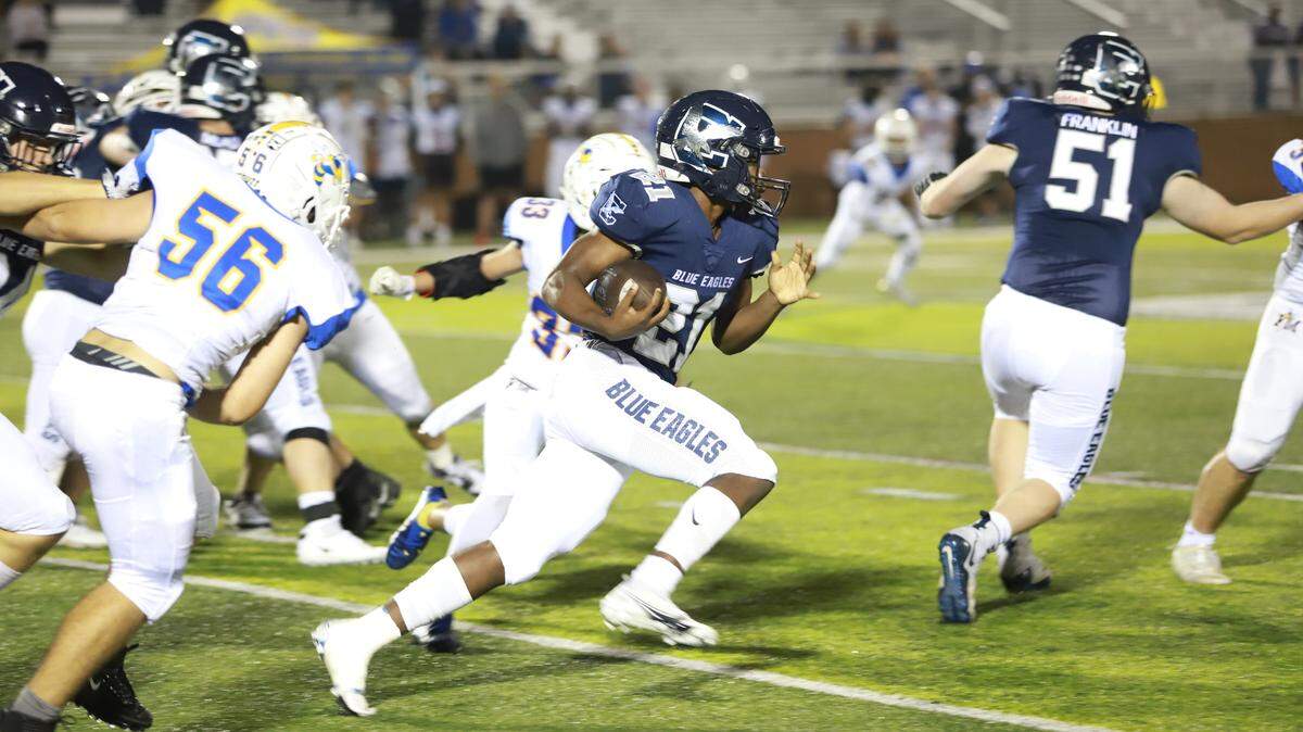 Clover’s Demarco Evans runs through the Fort Mill defense on Friday, Oct. 8, 2021.