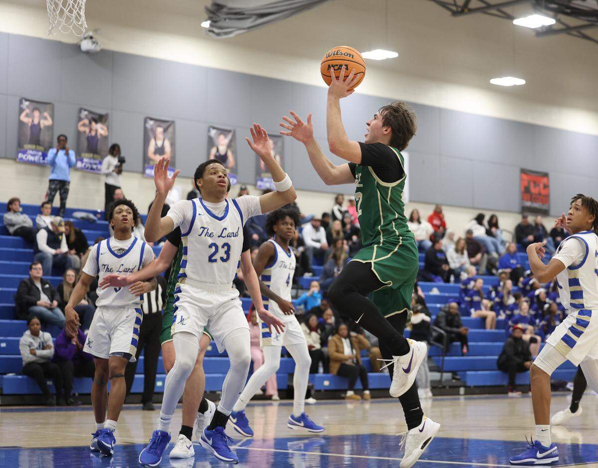 Catawba Ridge’s Casey Fikis heads to the basket as Indian Land’s Brent Michael Terrell defends in a 2024 game.