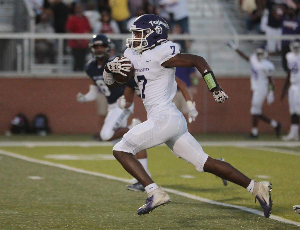 Northwestern’s Elijah Caldwell carries the ball to the endzone Friday as the Trojans and Blue Eagles compete in Clover.