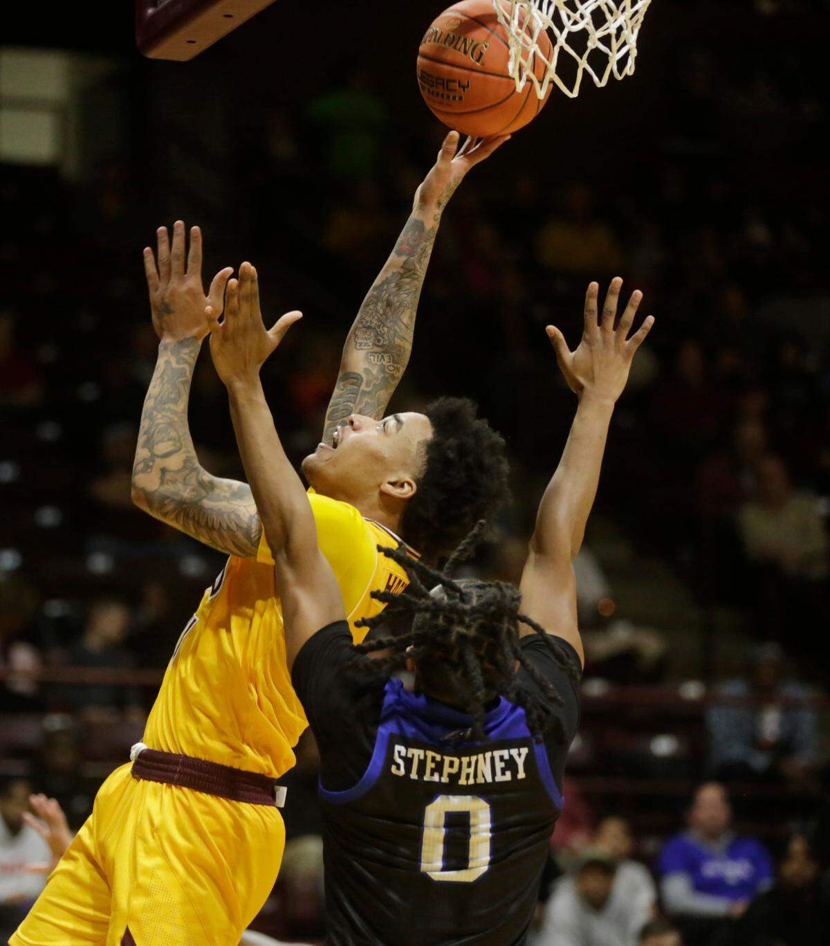 Winthrop’s Kasen Harrison puts up the shot against Asheville’s Trent Stephney