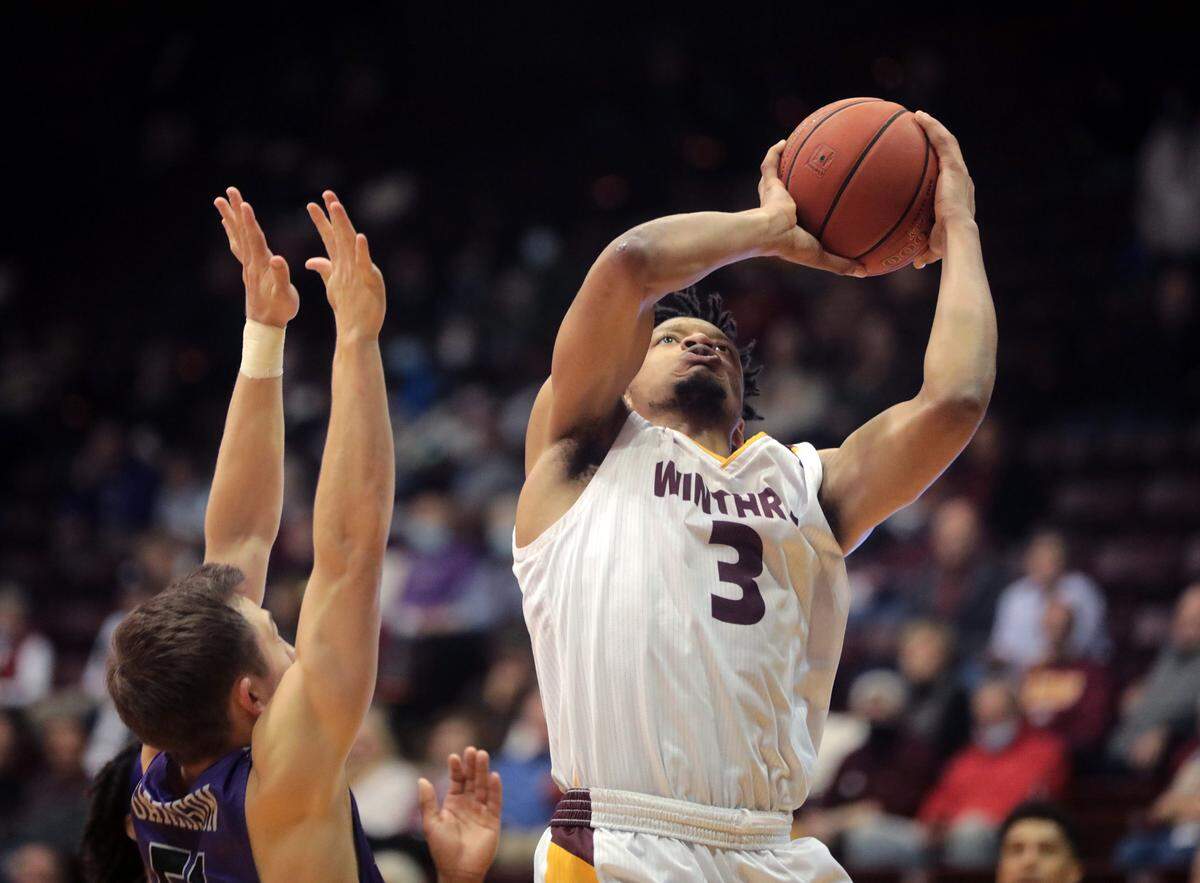 Winthrop’s Michael Anumba shoots the basket against Furman’s Conley Garrison