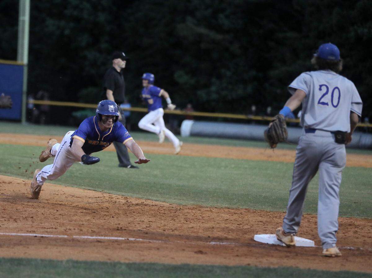 Fort Mill’s Eli Craddock dives into third base as Berkley’s Trey Minor watches the action.