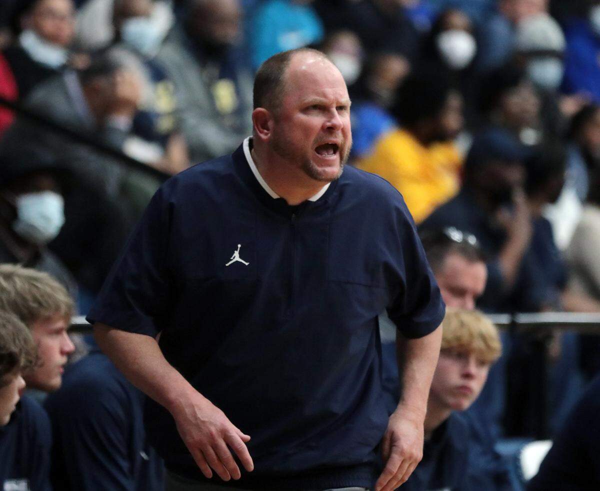 Clover boys varsity basketball coach Bailey Jackson yells towards his team.