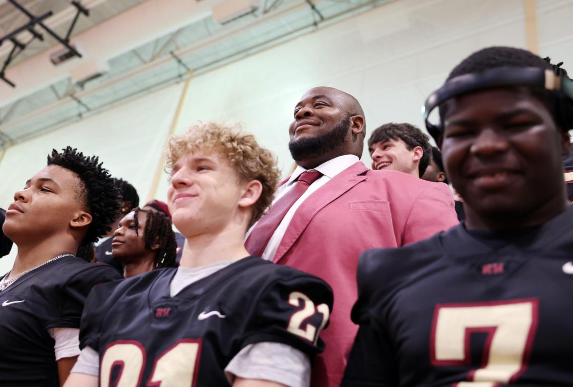 New Rock Hill High School head football coach Leon Boulware poses for photos Wednesday at the school, where he was introduced to the community.