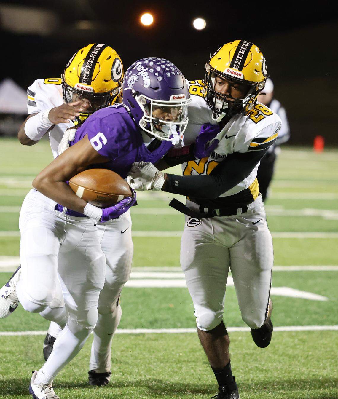 Northwestern’s Daniel Caldwell (6) is challenged by Greenwood’s Khamari Griffin (0) and Caleb Harris (28) Friday in Rock Hill, S.C.