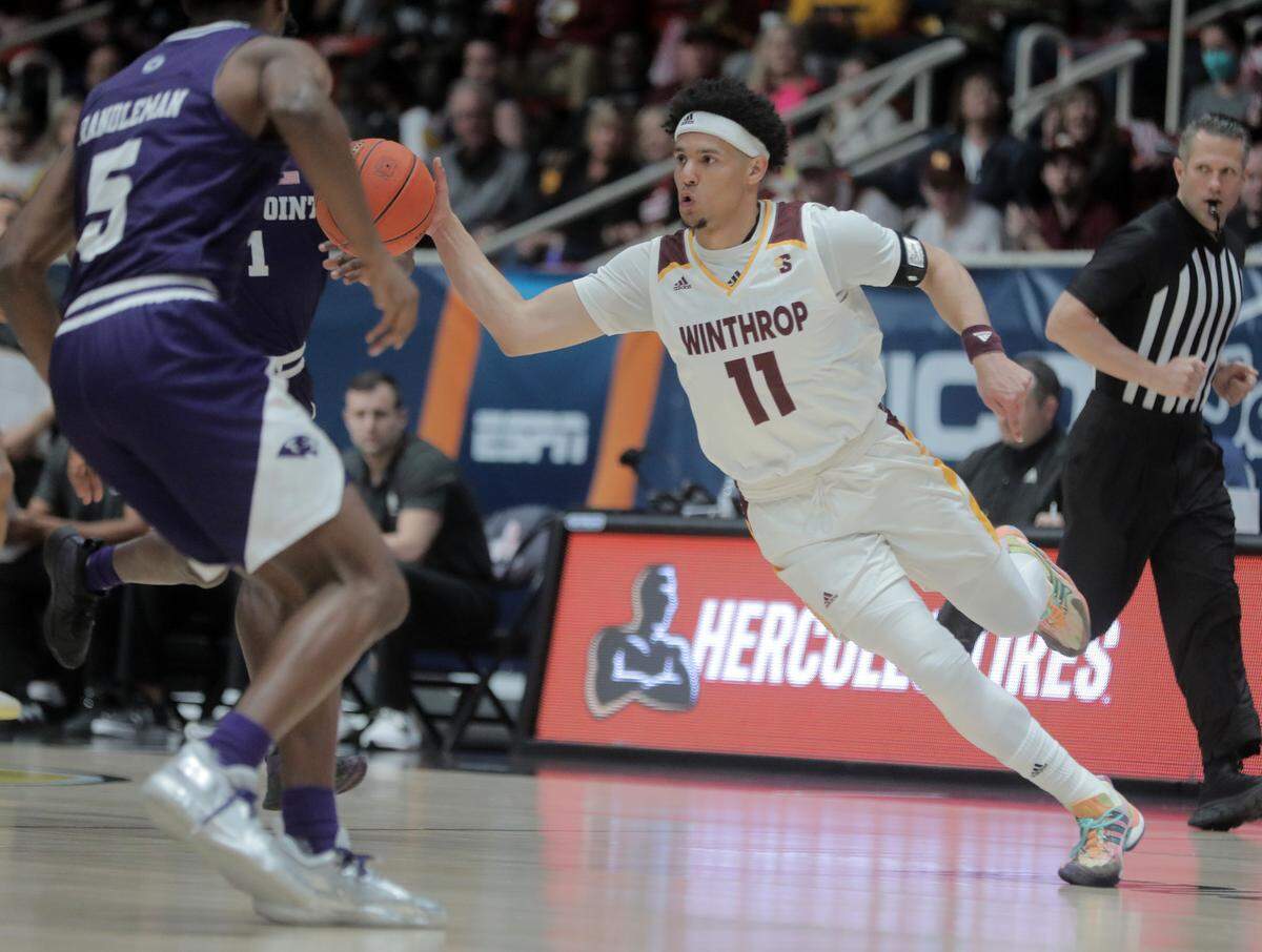 Winthrop’s Drew Buggs dribbles up the court in the first few moments of the Big South Championship game against High Point University on Friday, March 4, 2022 in Charlotte.