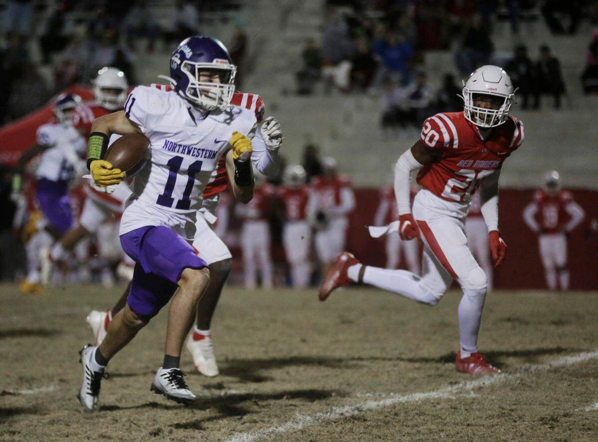 Northwestern’s Greer Hopkins carries the ball during the first half of the class 4A Upperstate Championship game against Greenville HIgh School Friday in Greenville.