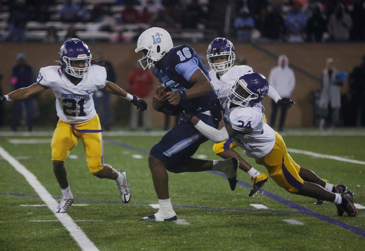 South Florence quarterback Lanorris Sellers (16) carries the ball as Northwestern’s Mason Davis (24) and Justin Spencer (21) try to stop him Friday at the Class 4A State Championship in Columbia.