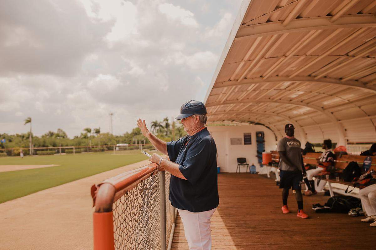 Joe Hudak directs his team from the dugout on a mission trip to the Dominican Republic this month.