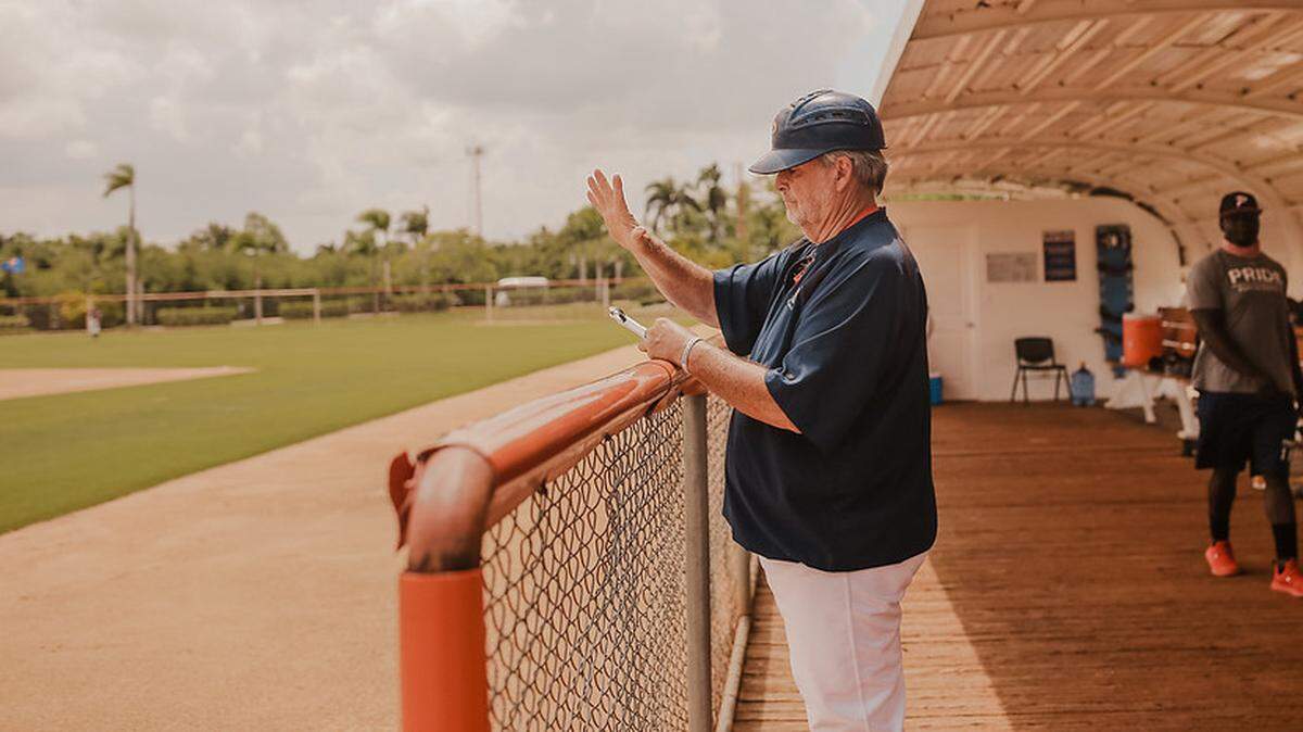 Joe Hudak directs his team from the dugout on a mission trip to the Dominican Republic this month.