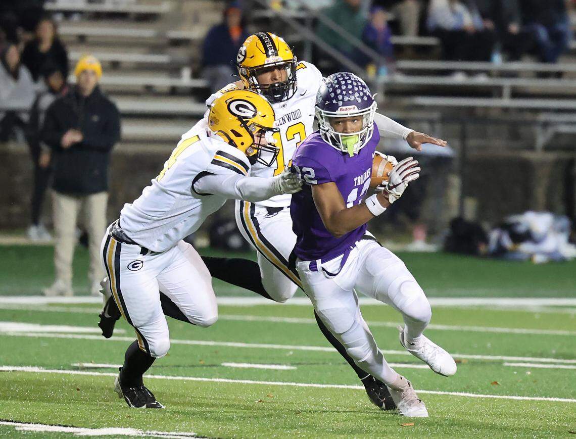 Northwestern’s Jonathan Spurgeon carries the ball as Greenwood’s Bryce Seaborn (4) and Eli Thomas (13) try to stop the play Friday in Rock Hill, S.C.
