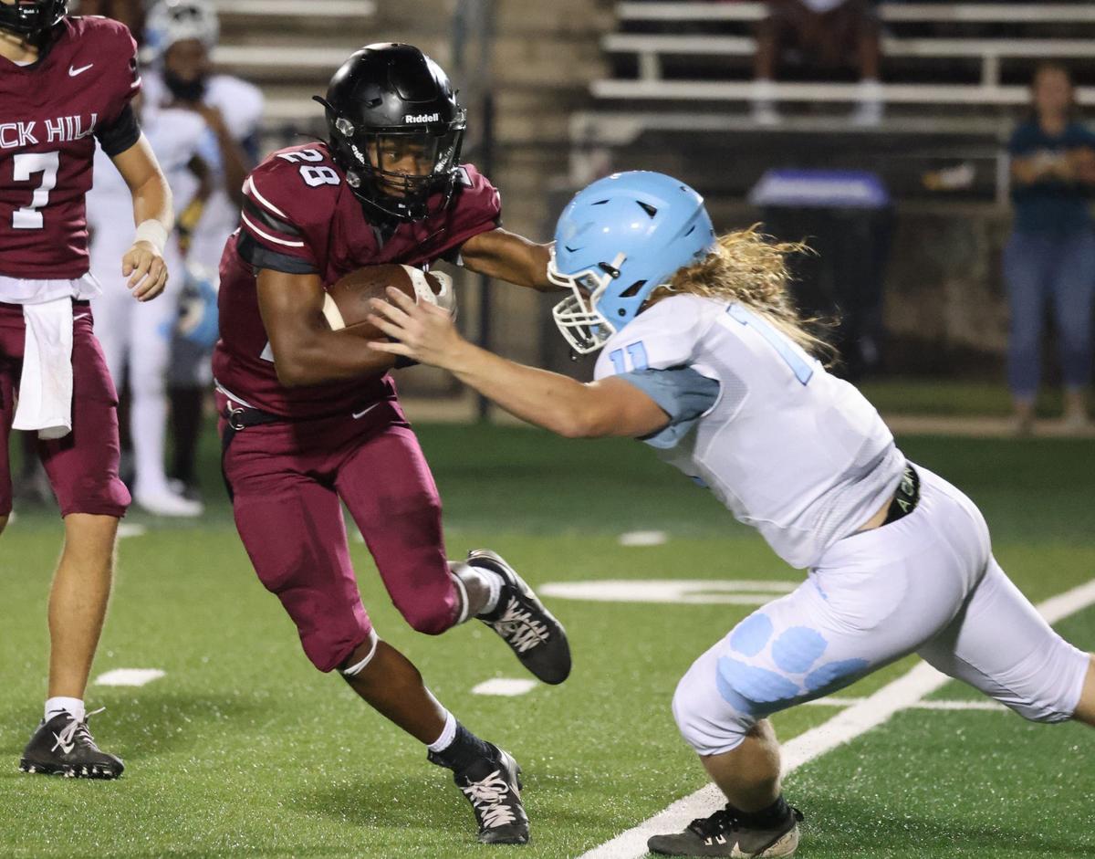Rock Hill’s Zac Jackson tries to hold off Hunter Huss’s Wesley Gunn Friday at the WRHI Football City USA scrimmage.