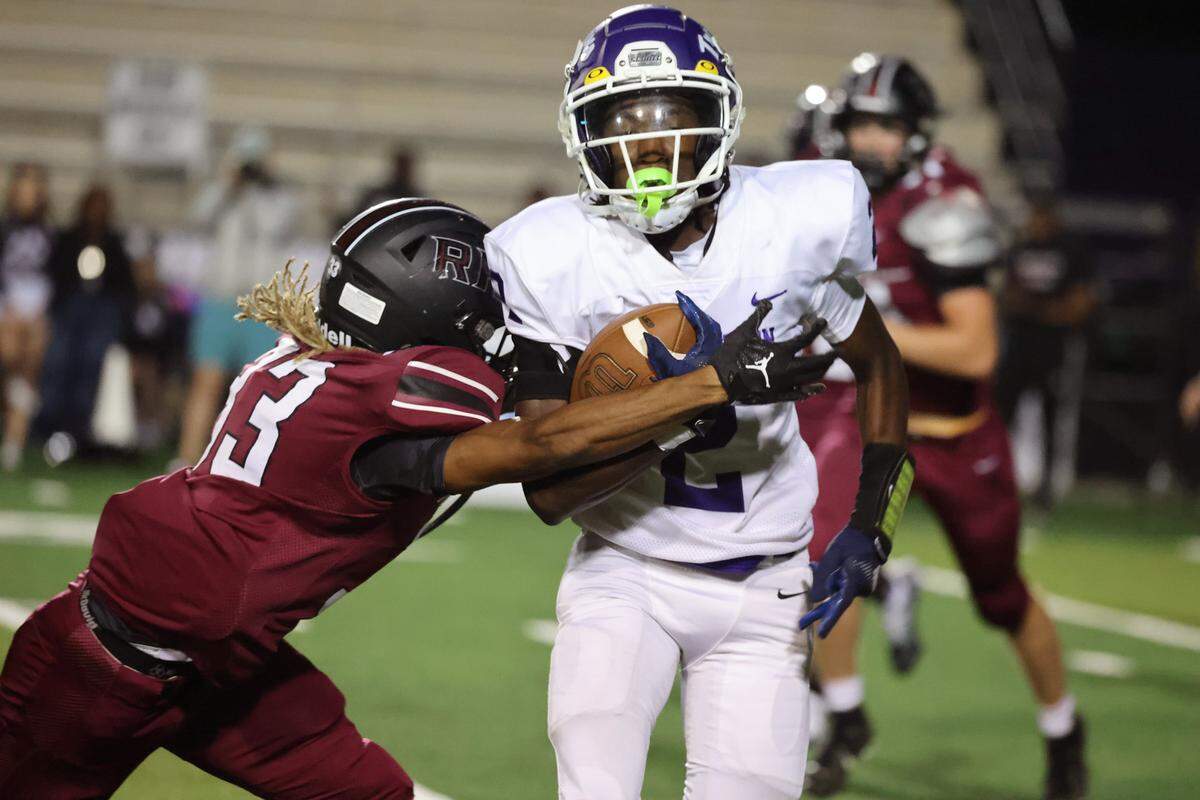 Rock Hill’s Travis Wesley tries to bring down Northwestern’s Jayden Nichols.