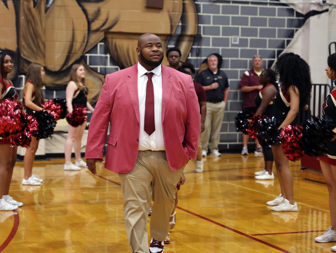 New Rock Hill High School head football coach Leon Boulware walks into the gym Wednesday at the school, where he was introduced to the community.