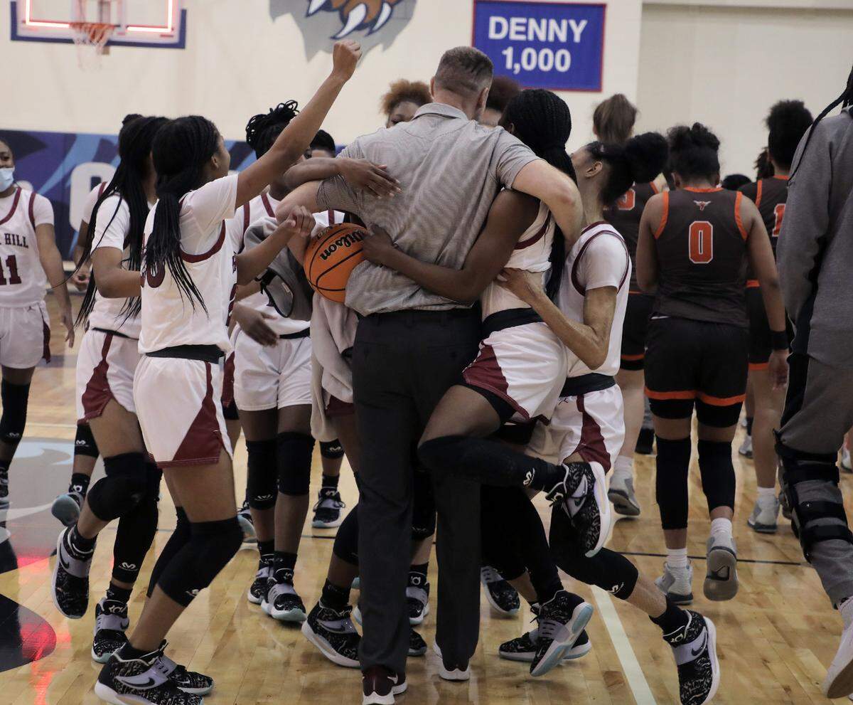 The Rock Hill High School girls basketball team celebrates after winning the Upper State championship in Greenville.