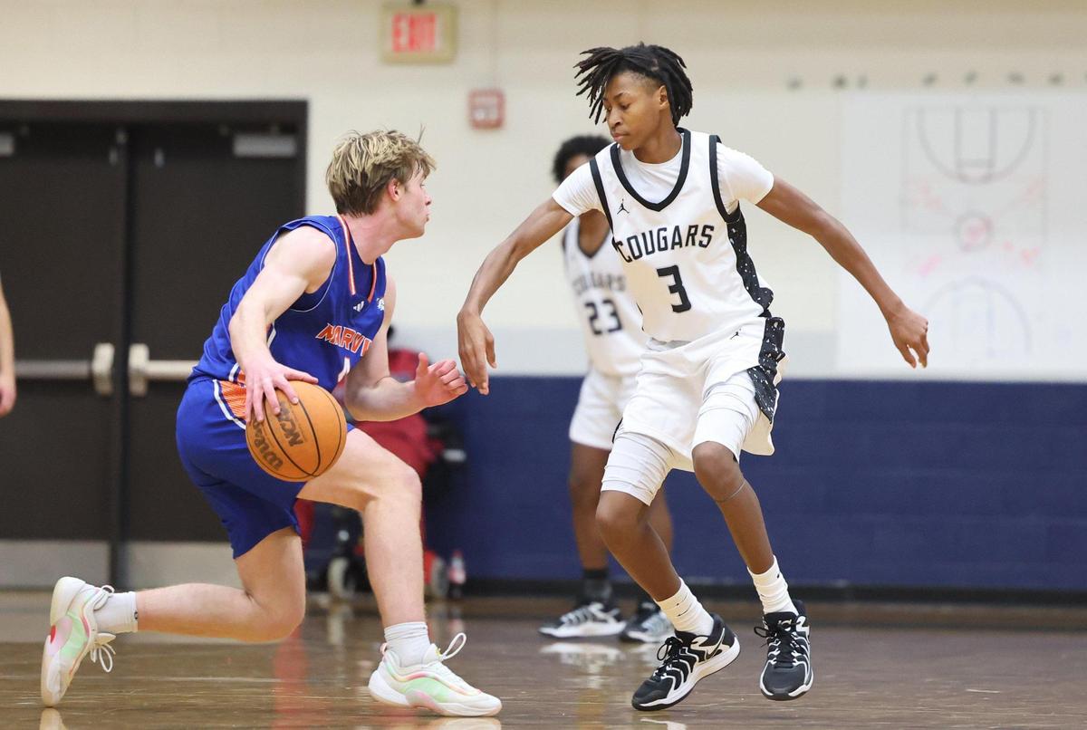 Marvin Ridge’s Marshall Payne, left, dribbles around York’s Peyton Lowery Saturday at Showdown at the Border